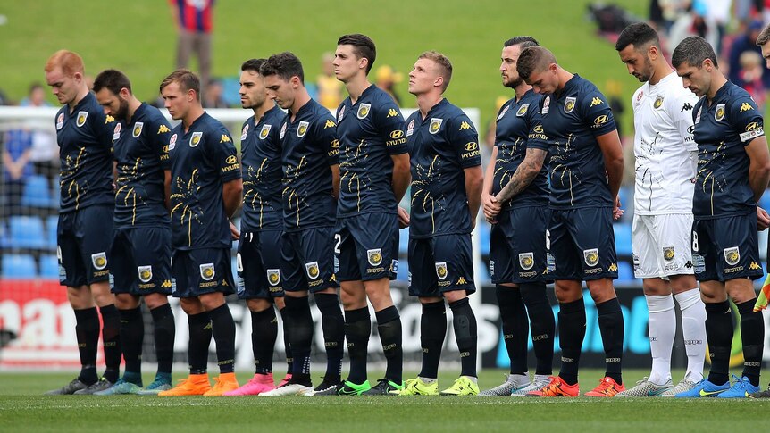 Central Coast Mariners players stand before match