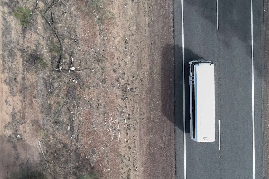 A top-down view of a bus on a country road