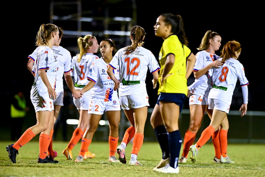 Holly McQueen celebrates with her teammates