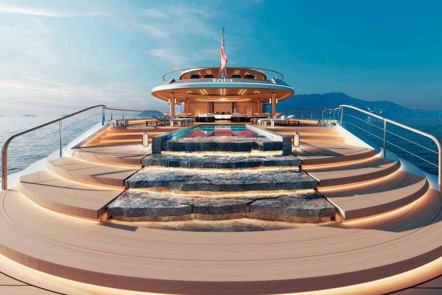 Top deck of the Aqua Superyacht features cascading water and a helicopter landing pad.