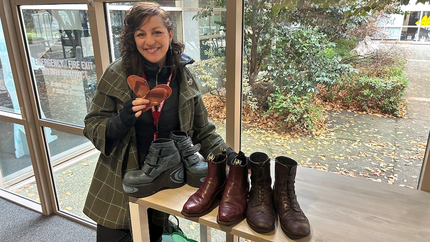 Monique Brumby with three pairs of boots and some tiny thongs.