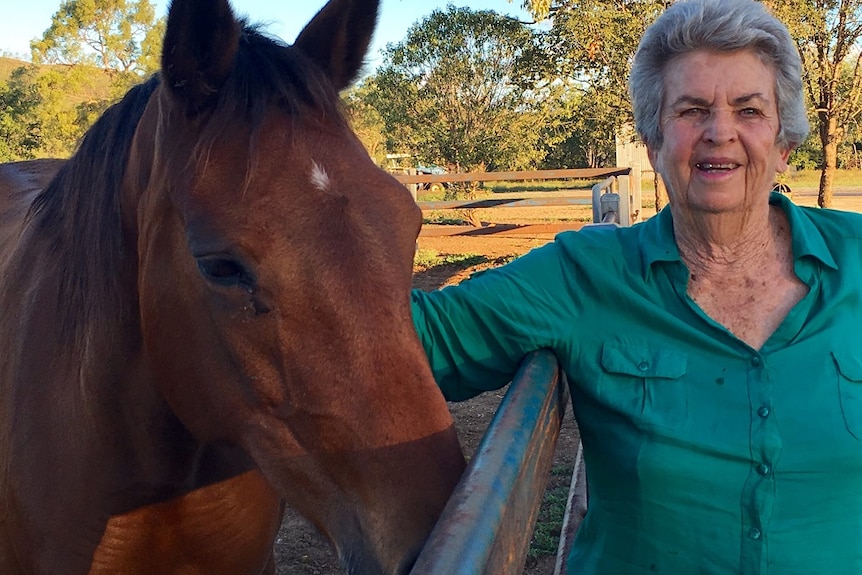 Yvonne Cox stand with one of her station horses.