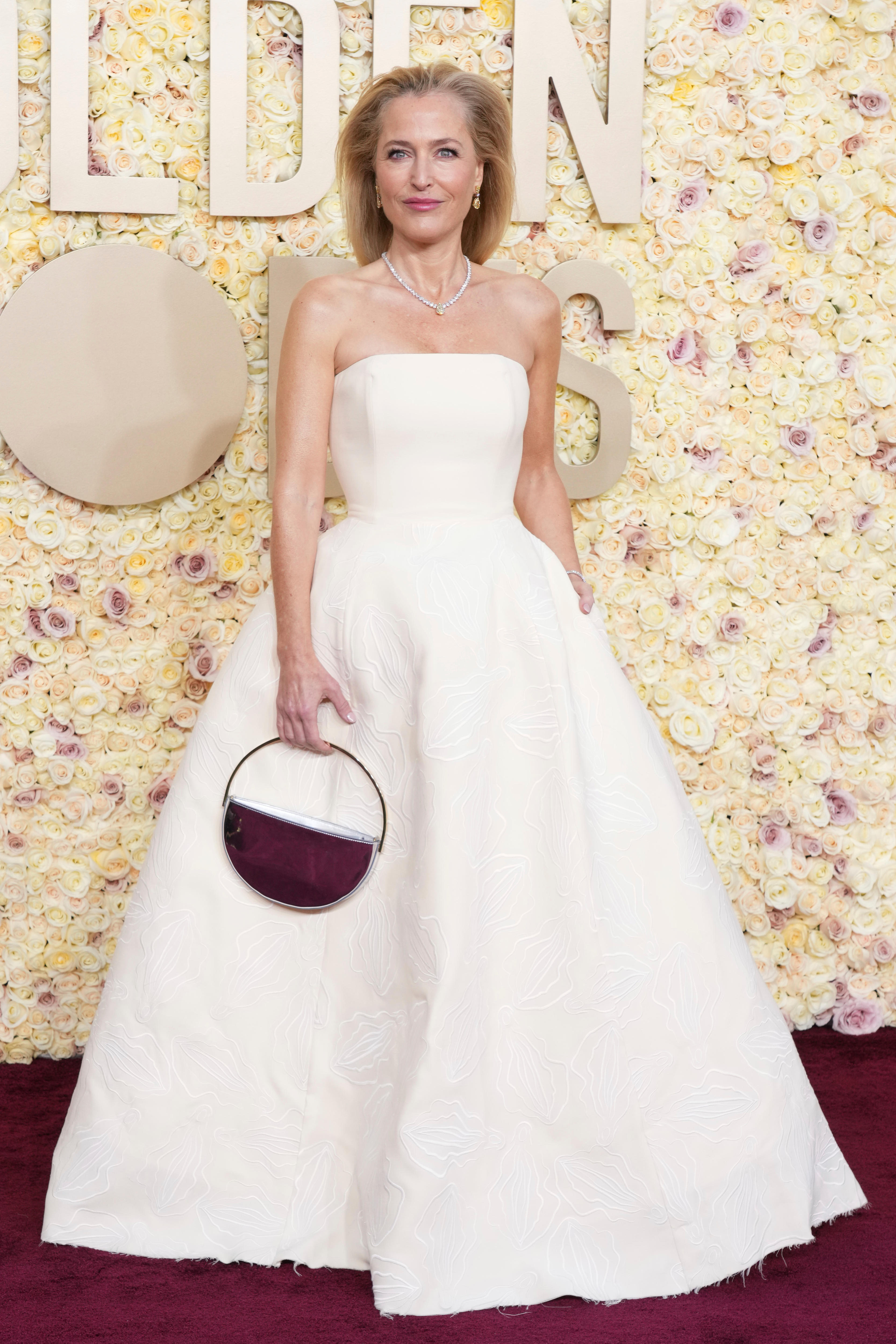 An actress on the red carpet in a white gown