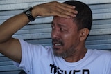 A Marawi police officer holds his forehead as he recounts his escape from Islamic State.