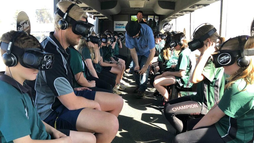 Students wear virtual reality headsets in the Beef Bus, an immersive tour of the beef industry.