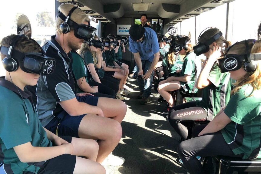 Students wear virtual reality headsets in the Beef Bus, an immersive tour of the beef industry.