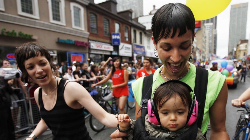 Lesbian couple and parents with their daughter