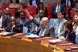 Russia U.N. Ambassador Vassily Nebenzia with his hand raised to veto extension 