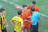 Brisbane Roar's Matt McKay debates with referee Alan Milliner after game with Phoenix is called off.