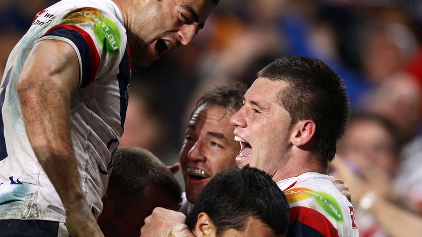 Roosters centre Shaun Kenny-Dowall celebrates with team-mates after scoring the match-winning try