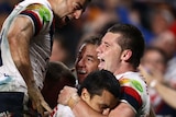 Roosters centre Shaun Kenny-Dowall celebrates with team-mates after scoring the match-winning try