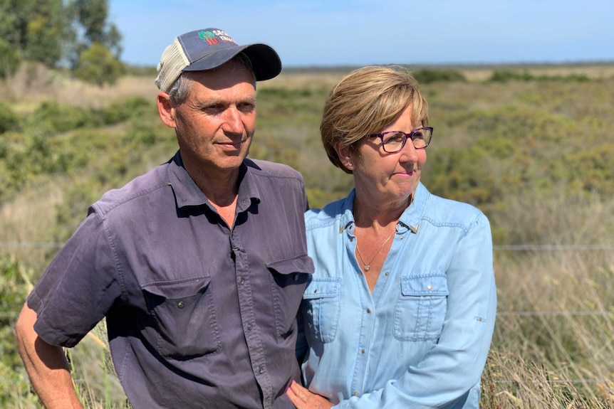 John and Sue Allnut standing on their property at Pearcedale, Victoria.