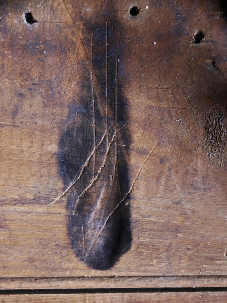 Burn mark on wall, thought to ward off evil spirits, in Tasmania.