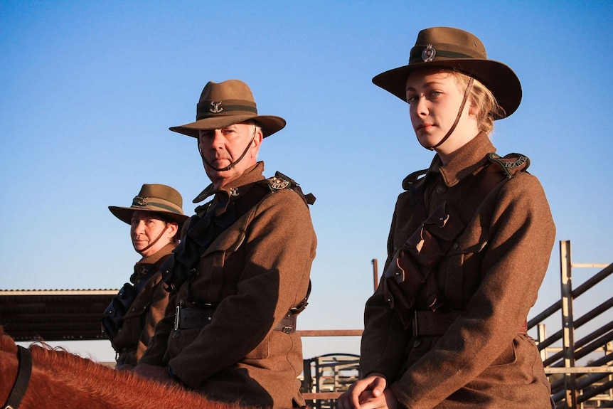 Three people dressed in New Zealand WWI uniforms on horseback