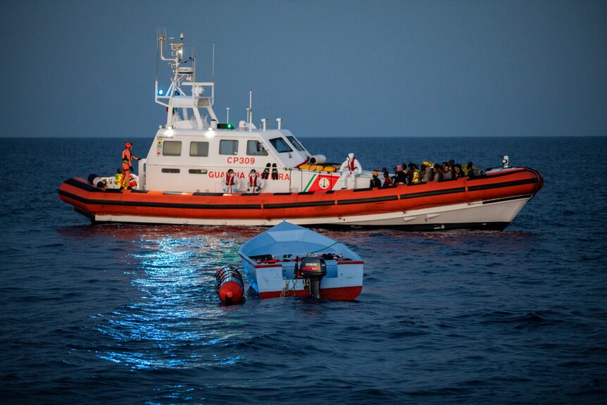 Migrants on a coast guard boat.