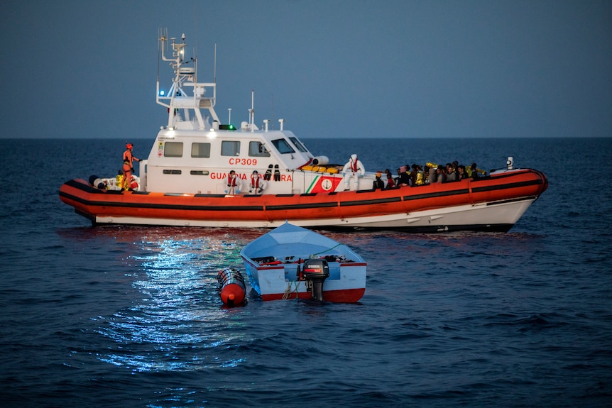 Migrants on a coast guard boat.