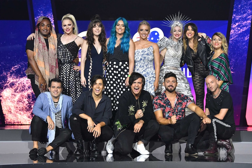 A group of people pose for a photo on stage