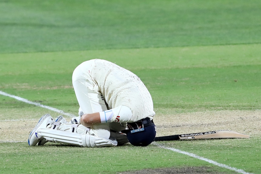 Joe Root his bent over double in the fetal position