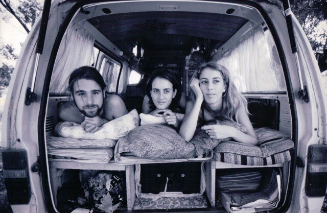 A band sitting in the back of a van.