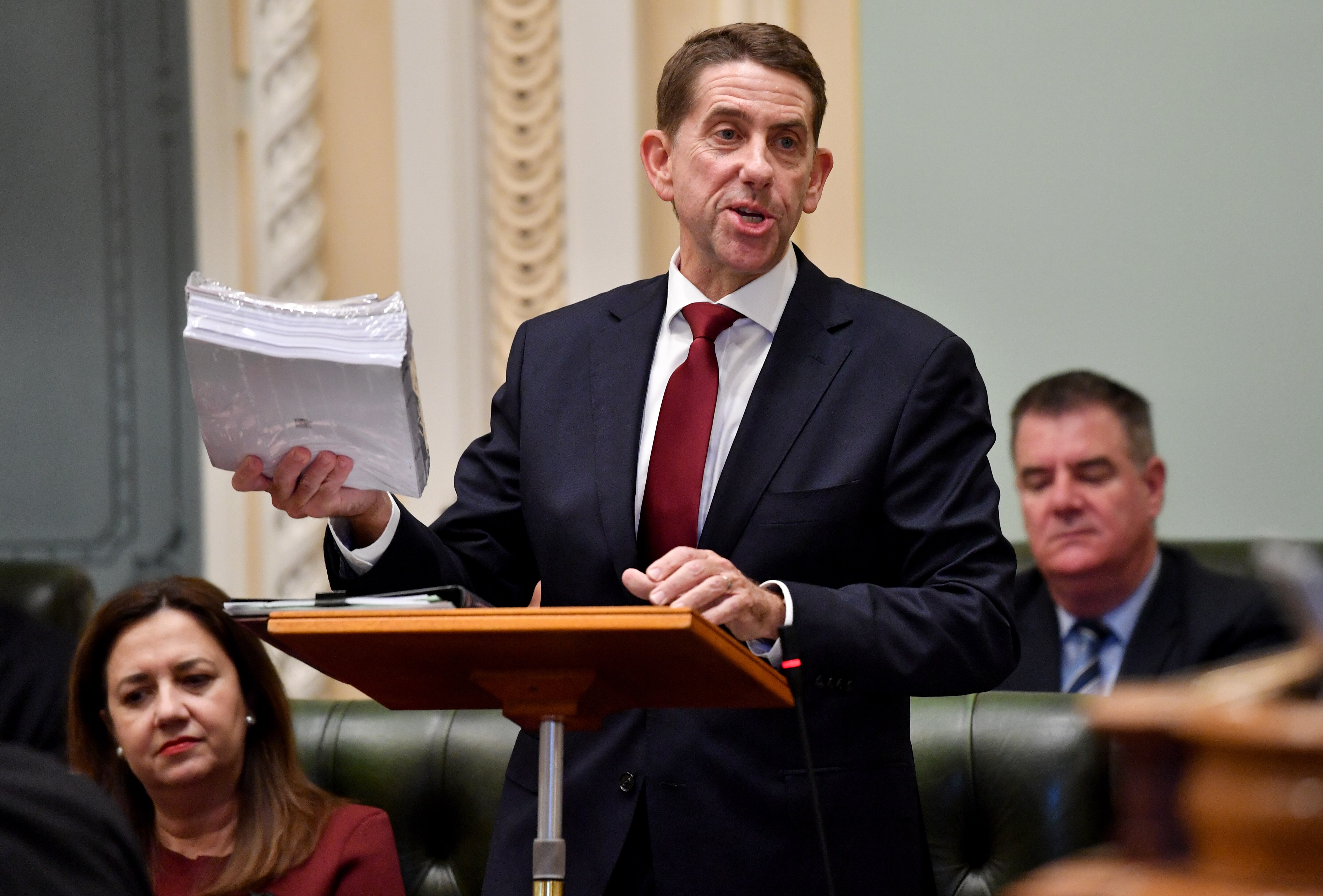 Cameron Dick holds budget papers.