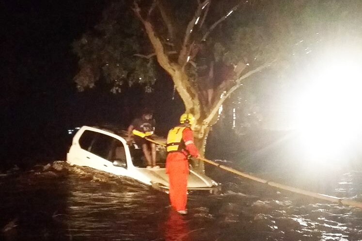 Two women and a man had to be rescued after their small 4WD washed off a causeway in Central Australia.