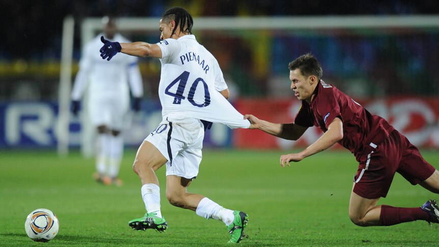From Russia with love ... Rubin Kazan's Aleksandr Ryazantsev vies with Tottenham's Steven Pienaar.