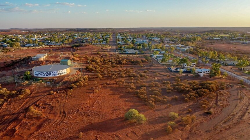 Drone picture from the air of the town of Meekatharra. A water tower with "Welcome to Meekatharra" stands in the foreground 