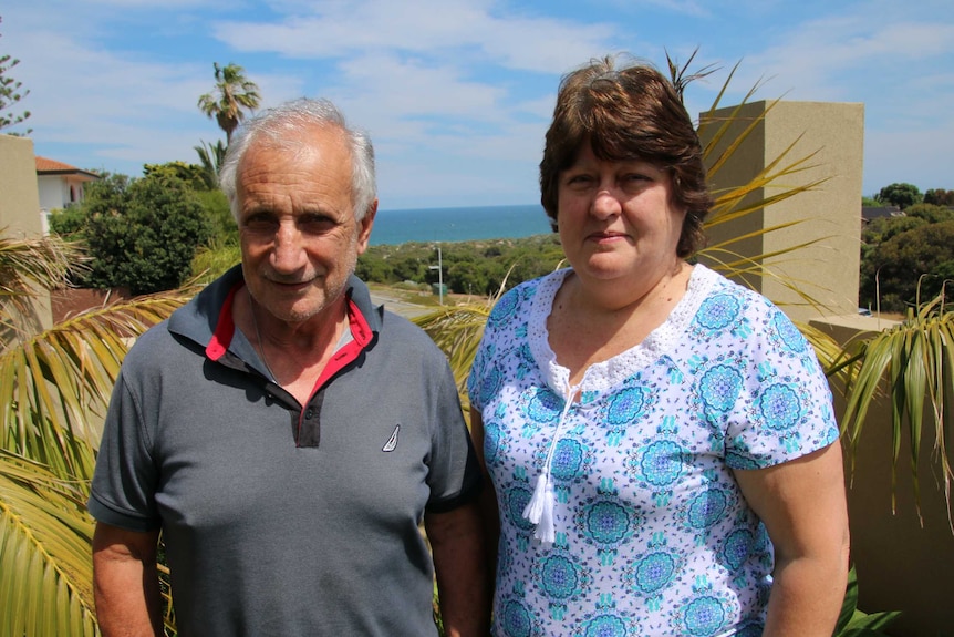 Gino and Lina Scaffidi in broad sunshine standing in the garden of their City Beach home.