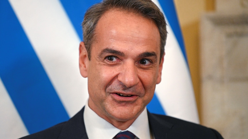 Close up of Greek PM's face as he smiles for cameras