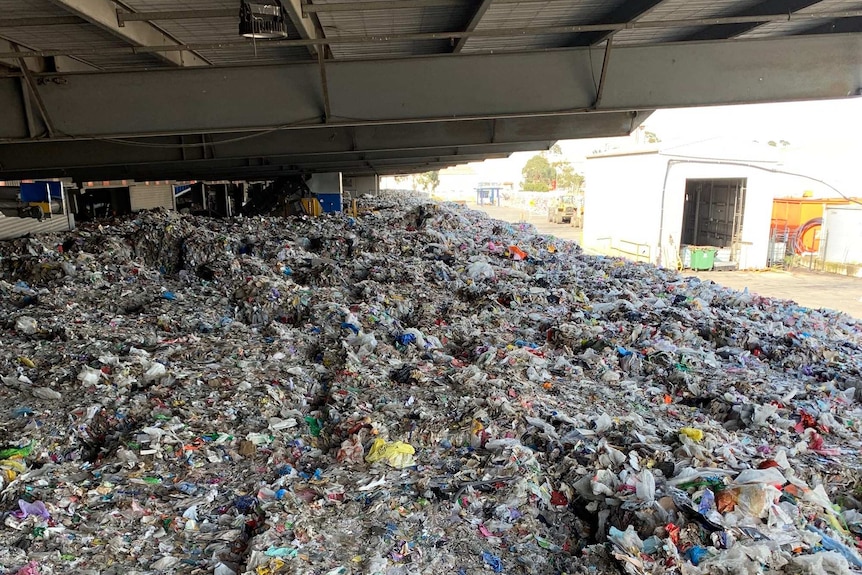 A huge stockpile of rubbish sits at a waste site.