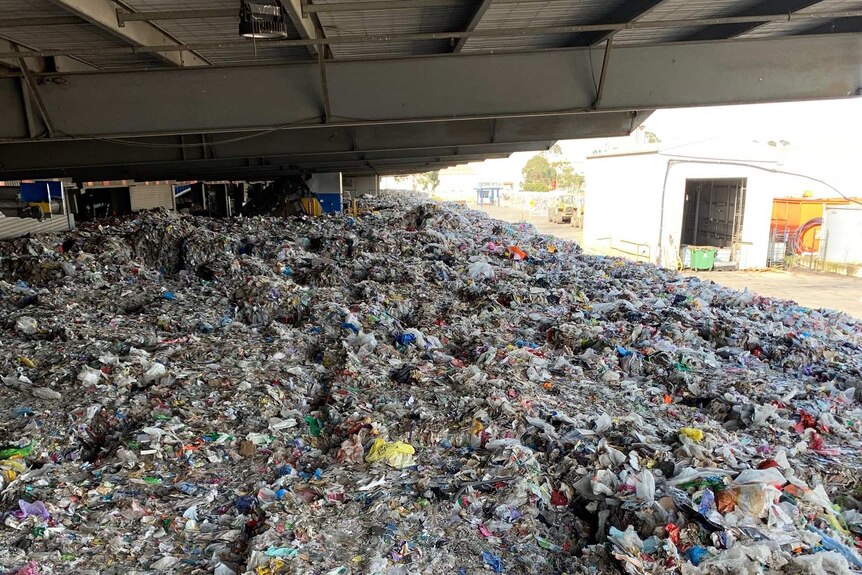 A huge stockpile of rubbish sits at a waste site.