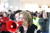 A staff member keeps passengers informed at Melbourne's Tullamarine airport