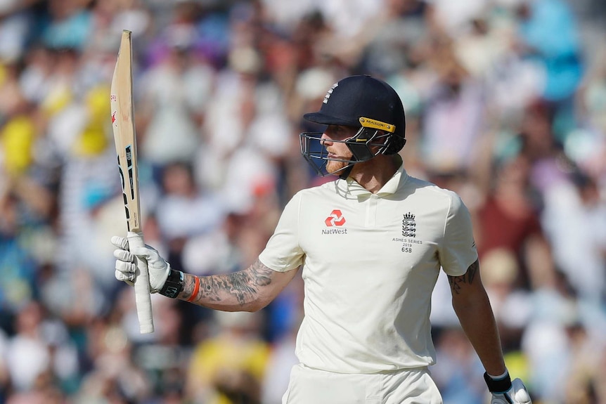 England bat Ben Stokes holds up his bat to mark his half-century in a test at The Oval.