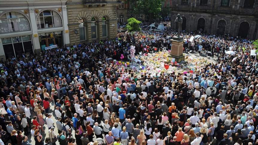 People pack a square in Manchester for a minute's silence.