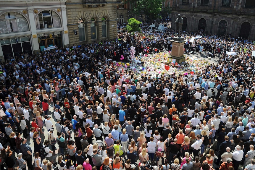 People pack a square in Manchester for a minute's silence.