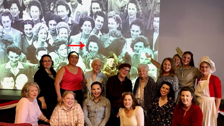 A large group of women in front of a projected image. 