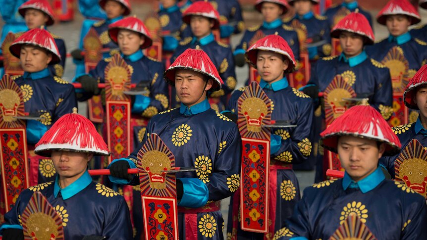 Performers take part in a traditional Qing Dynasty ceremony during the opening of an annual fair in Beijing.