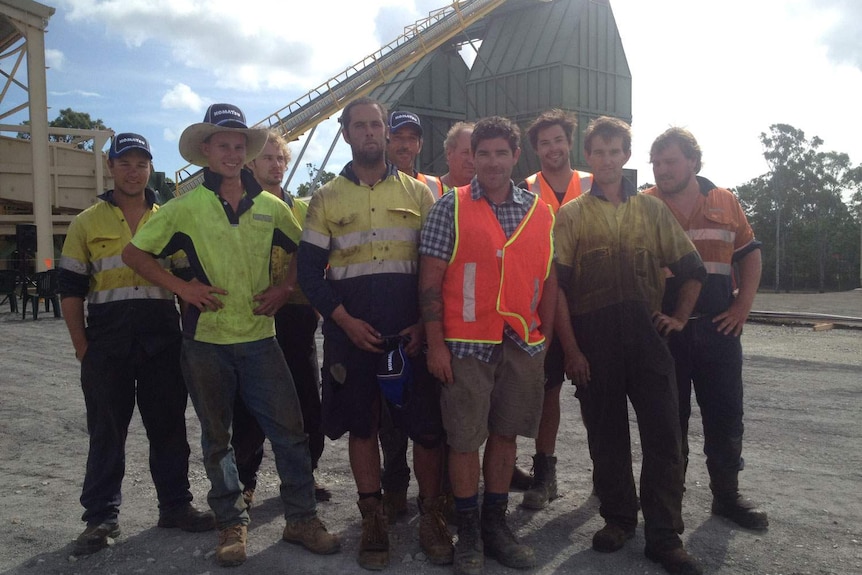 Timber Marshalling Services managing director Brendon O'Connor (in the orange vest in front row) with workers around him