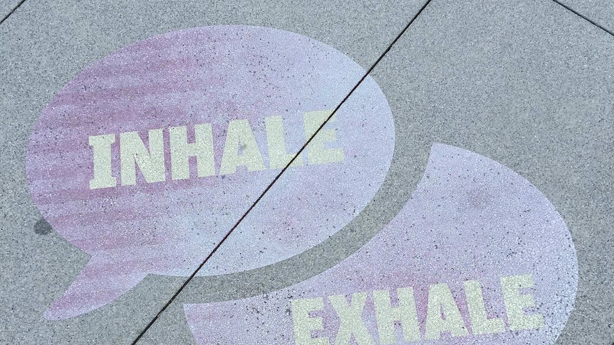 street art reading speech bubbles saying inhale and exhale