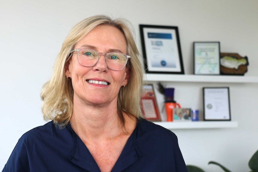 Headshot of a woman looking at the camera in an office.