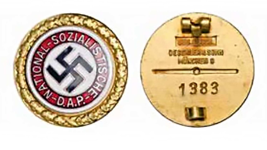 Golden Nazi badge showing a swastika as displayed in  an auction catalogue.