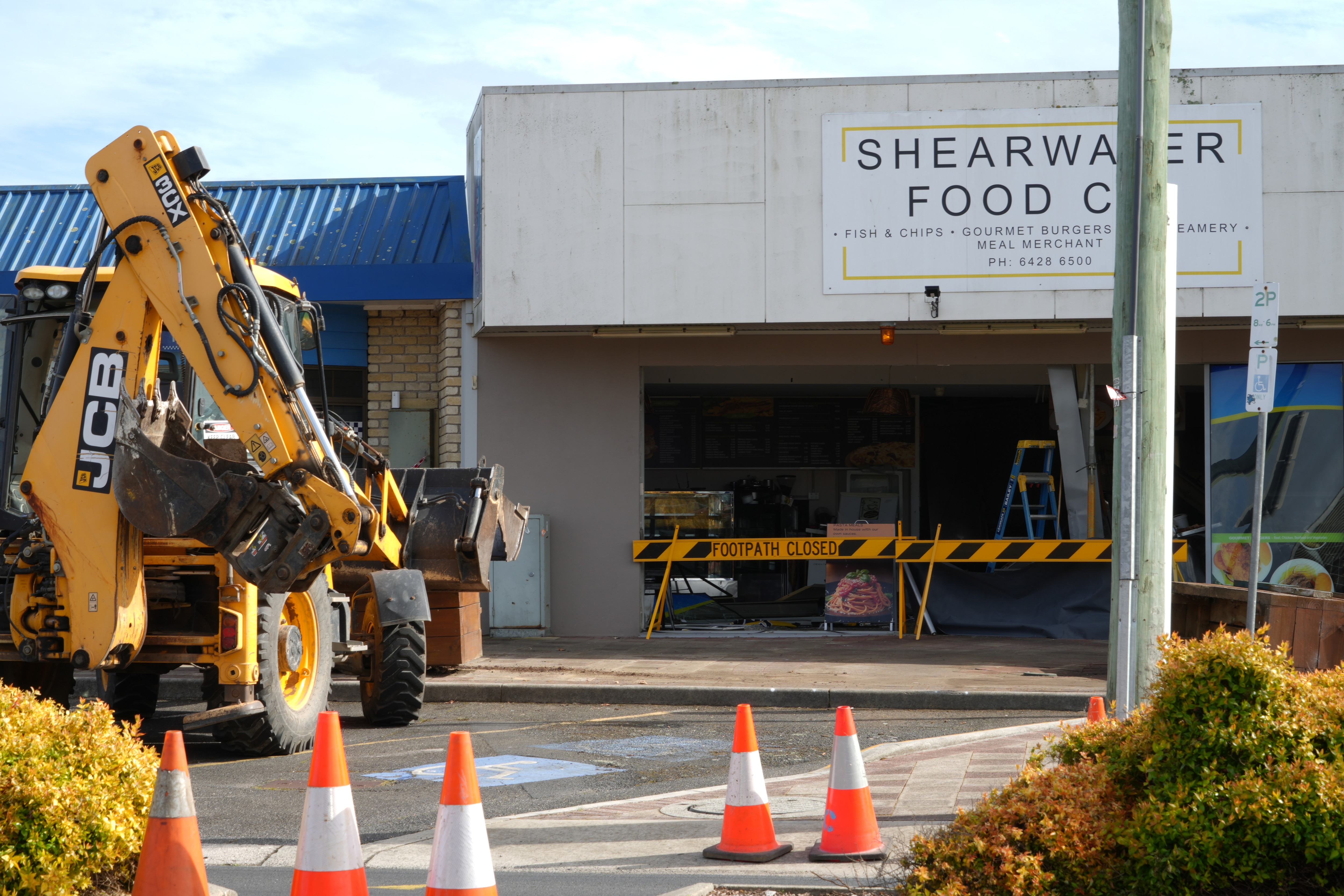 Damage to cafe business after car smashed through front wall.