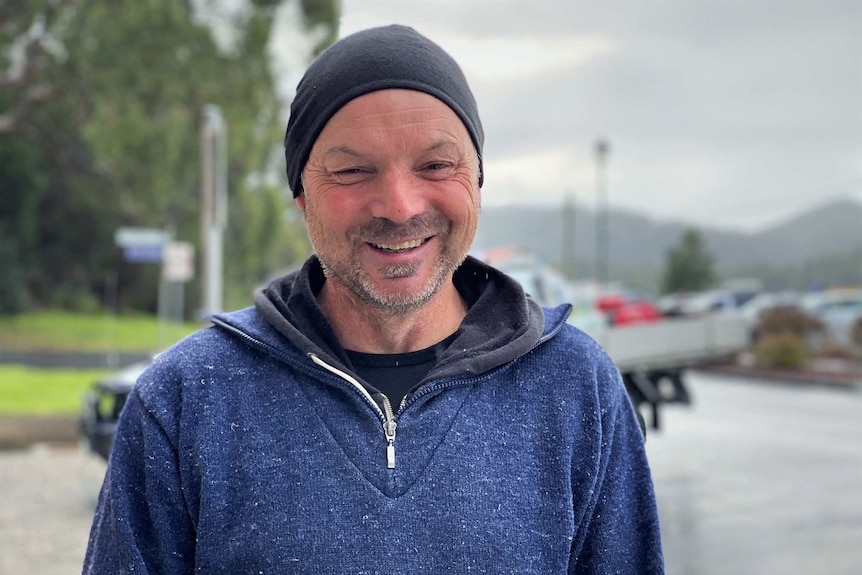 Wildlife biologist Sam Thalmann wears a beanie and blue jumper.