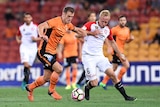 Luke De Vere of the Brisbane Roar (left) and Mitch Nichols of the Western Sydney Wanderers compete for the ball.