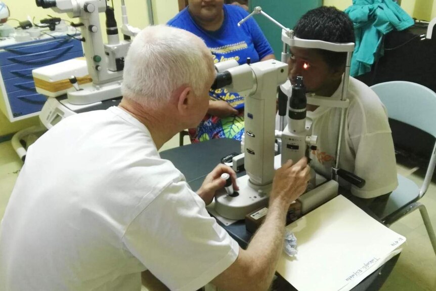 Doctor checking eyes of a child.