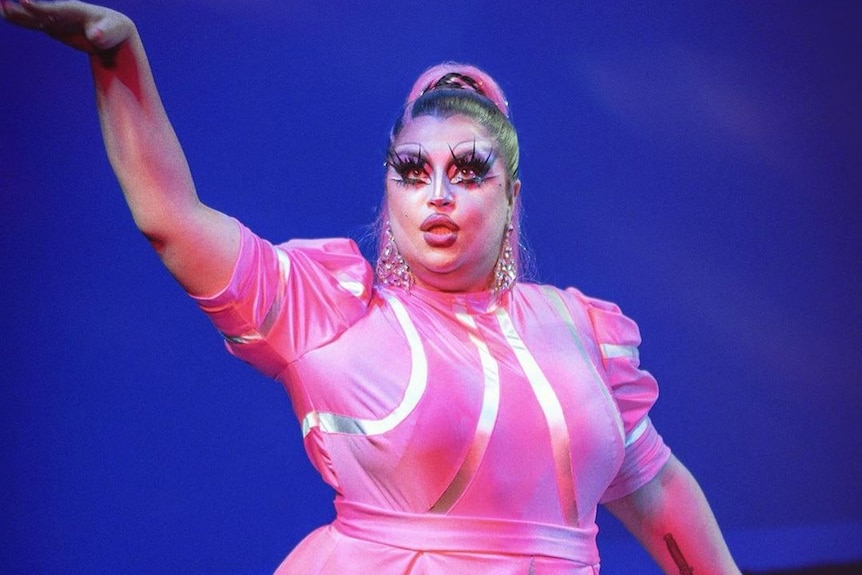 A drag queen in a large pink dress