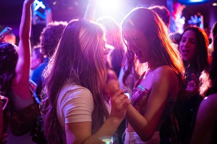 Two young women dancing in a nightclub.