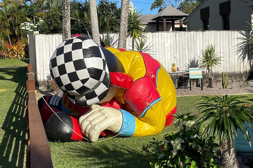 deflated large clown in the front yard