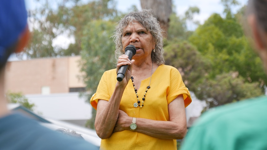A woman speaks into a mic