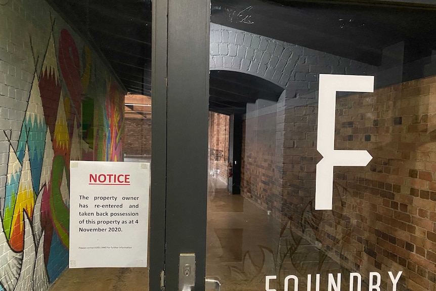 The front door of Foundry Launceston with a sign saying the property owner has taken possession of the building.